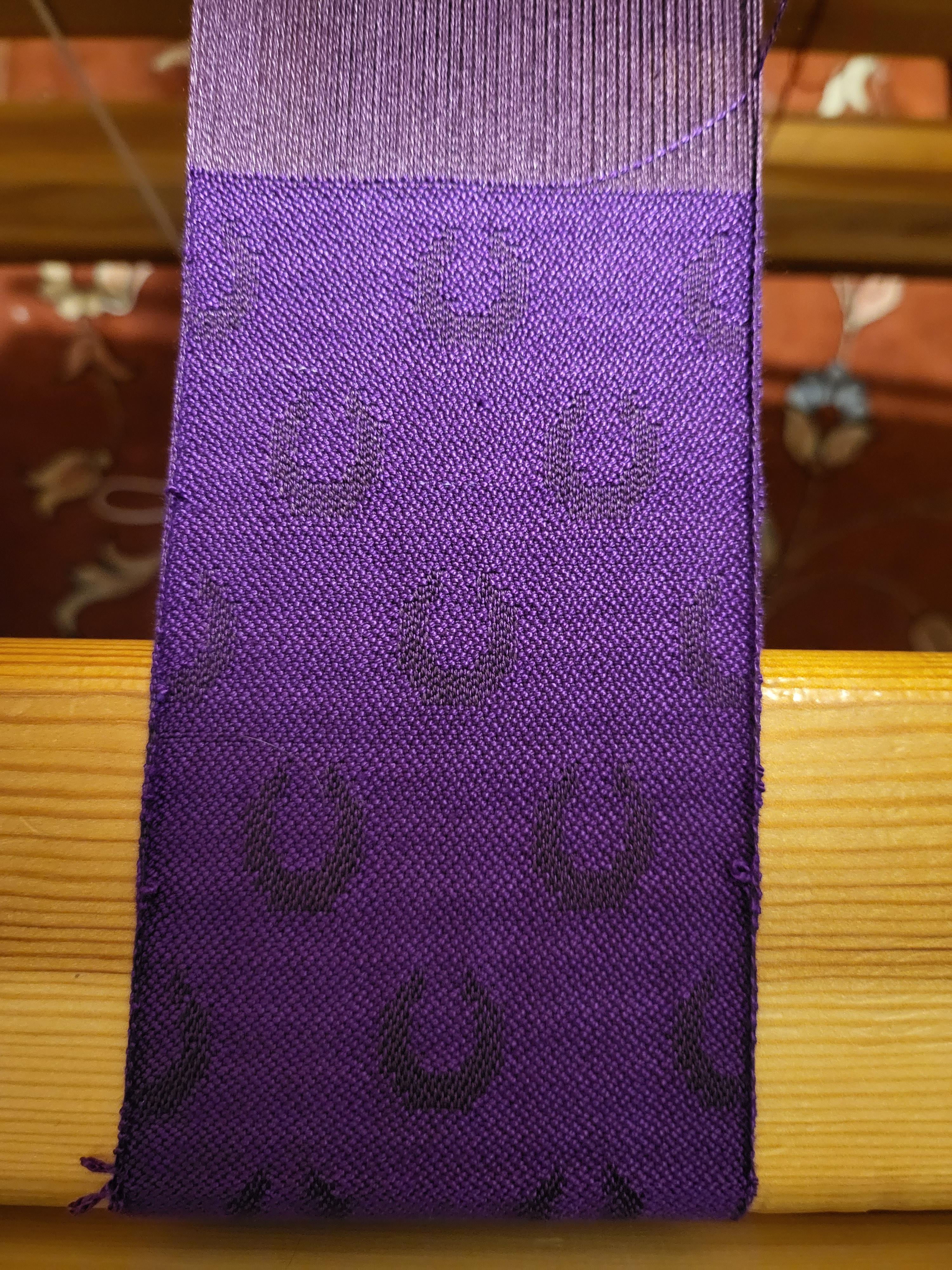 Dark purple crescents on a lighter purple background woven all in silk