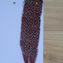 red cloth with grey diamonds woven in