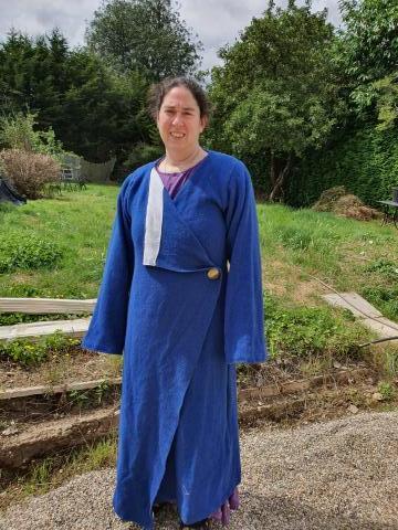 A woman wearing a blue handwoven robe.