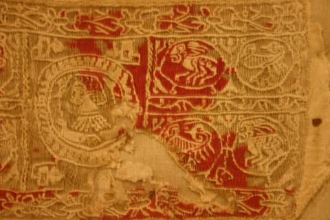 tapestry weaving with floral motifs and a bust within a circle