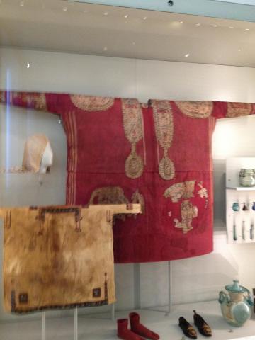 A red tunic with tapestry roundels and bands down the front